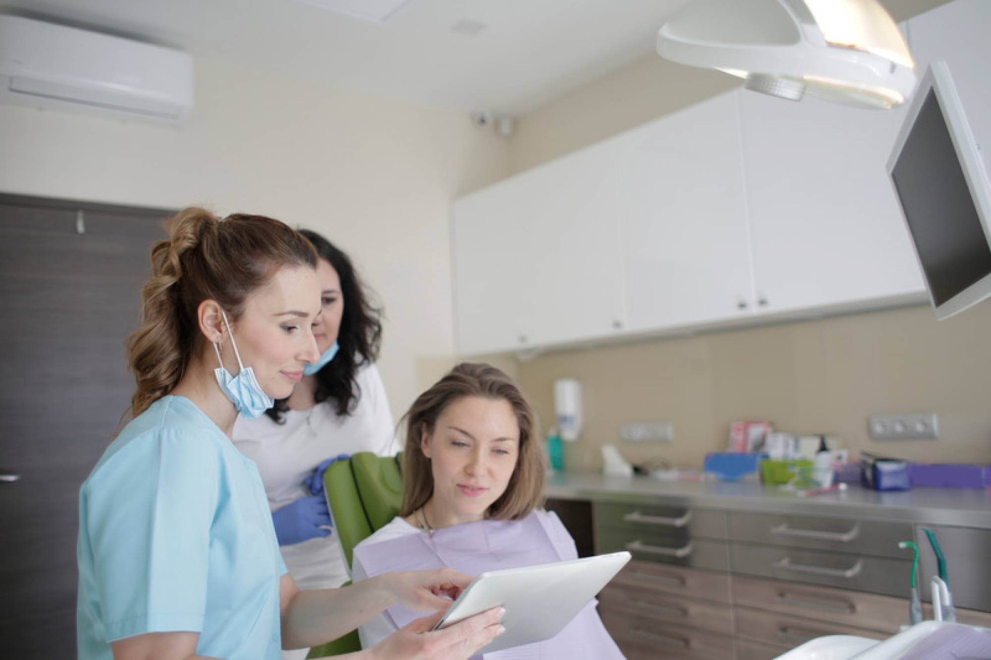 Canva - Patient Looking at the Dentist Tablet