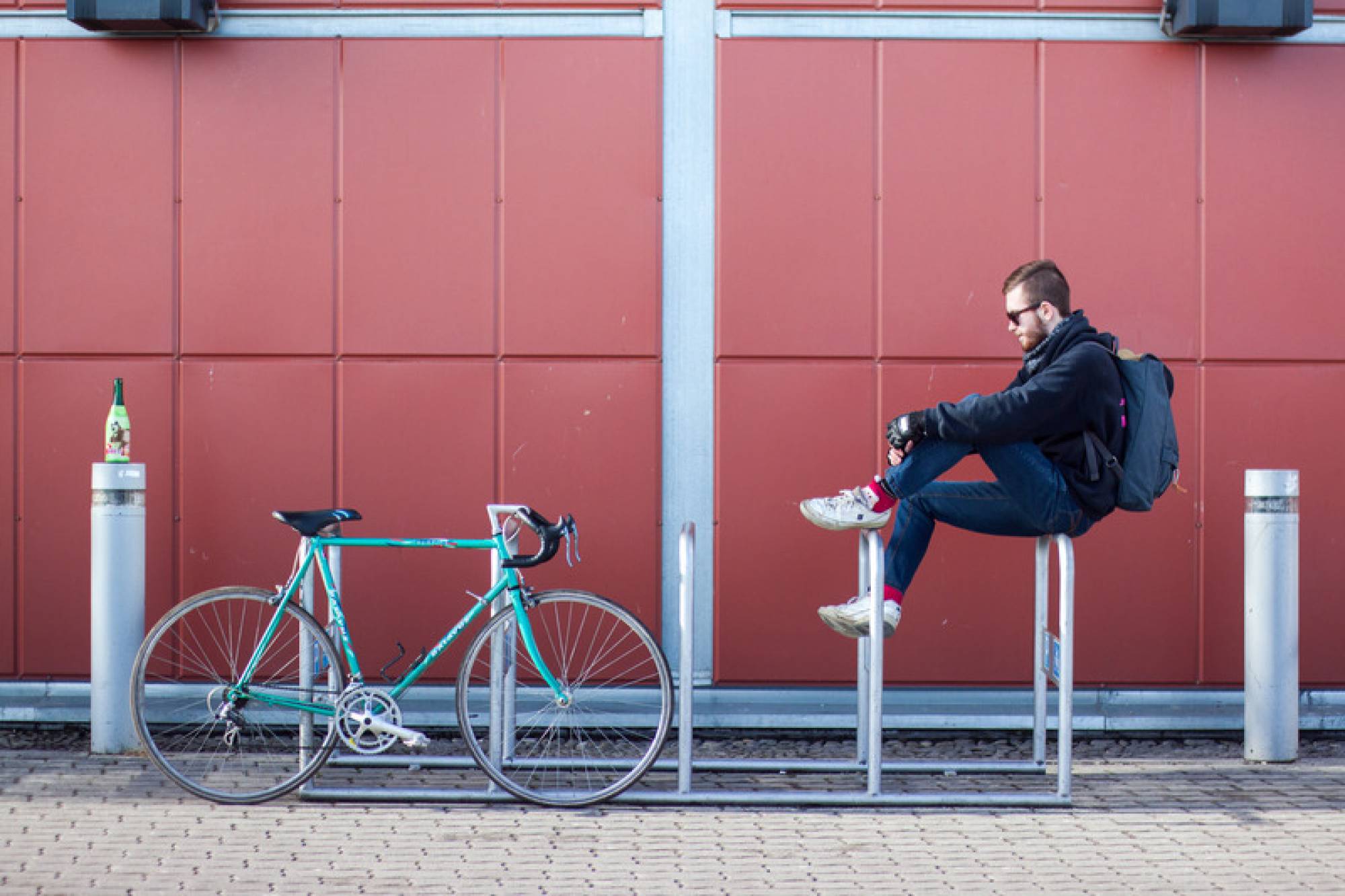 Canva - Man Sitting on White Bicycle Parking Space