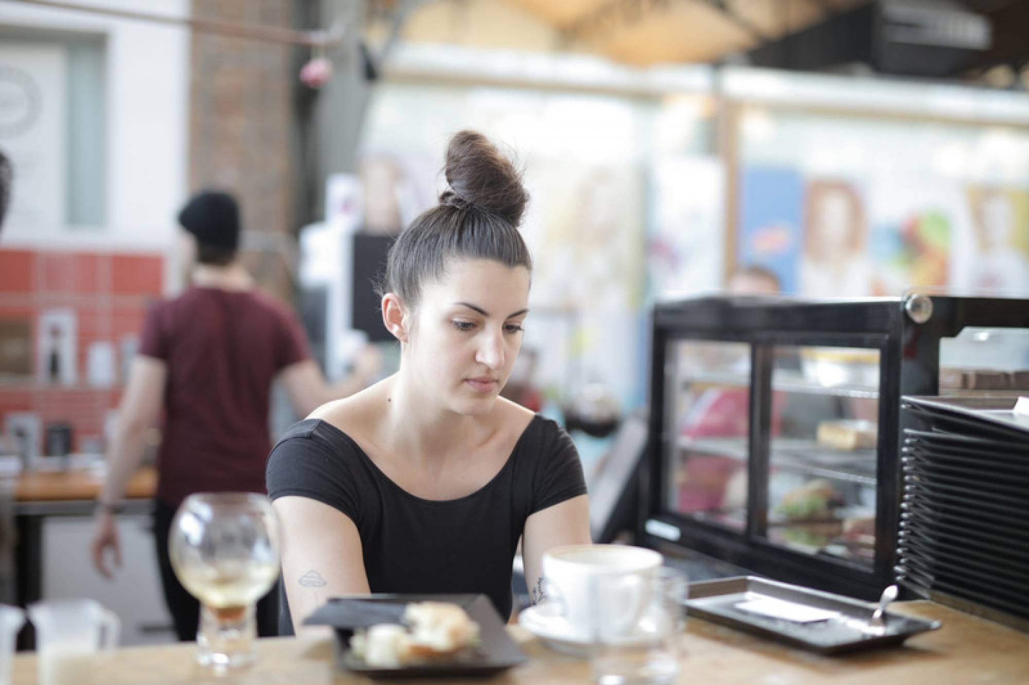 Canva - Woman in Black Scoop Neck Shirt Behind the Counter